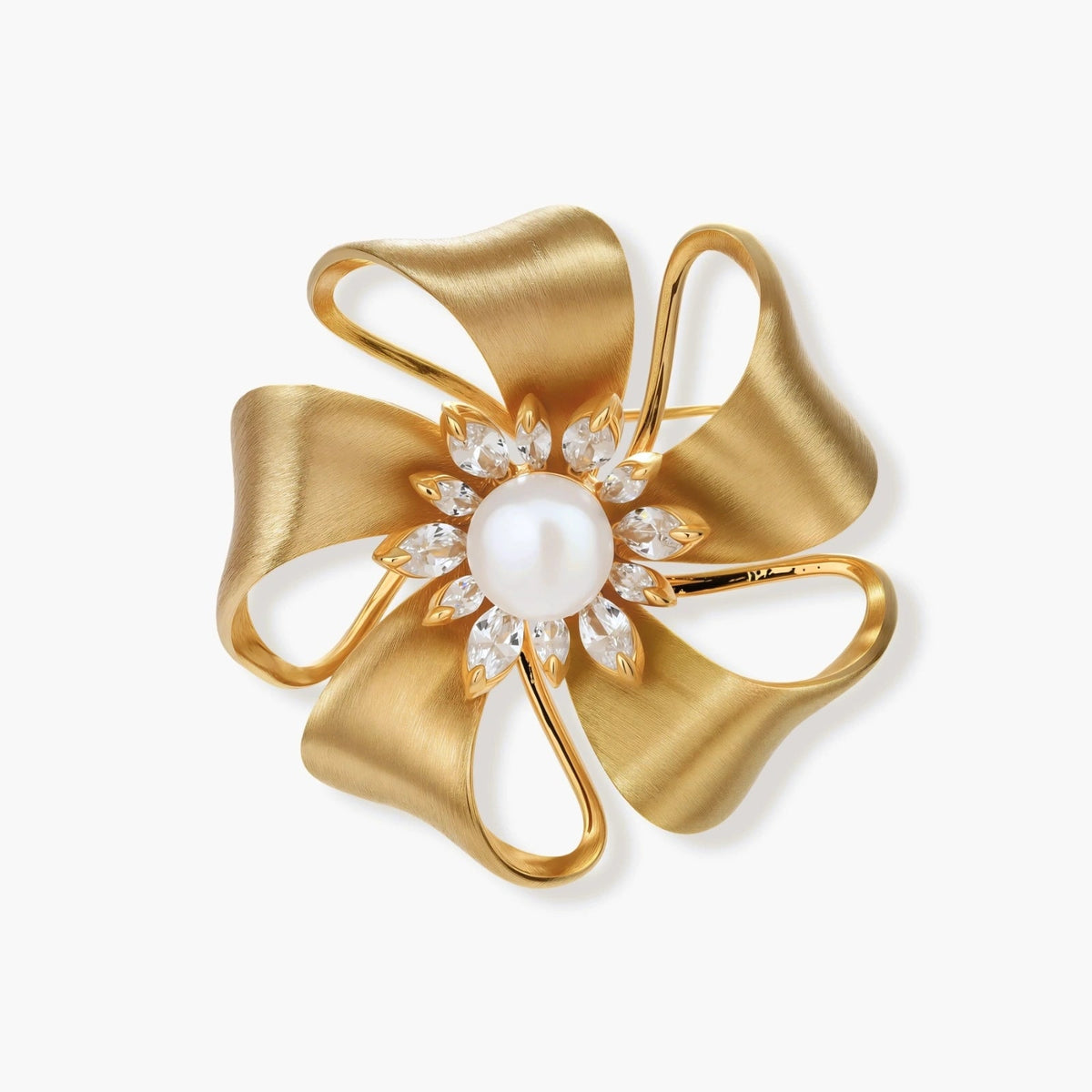 18K gold-plated floral pin with sculptural brushed petals, a pearl-like center, and zirconia accents on a white background.